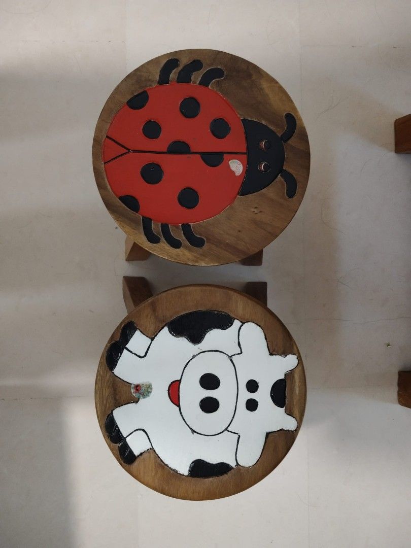 Solid Wood Table with Stools (Category: Tables & Sets) located in Singapore. Submitted by fluffycarrotz (Listing ID 1425550656, Image 3). Description: Adorable wooden table set, perfect for kids! Includes a round table and two stools, one with a ladybug design and the other with a cow. Great for playtime or a small dining area/coffee table. 85cm x 45cm.