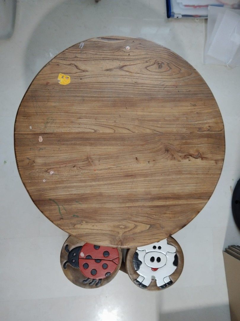 Solid Wood Table with Stools (Category: Tables & Sets) located in Singapore. Submitted by fluffycarrotz (Listing ID 1425550656, Image 2). Description: Adorable wooden table set, perfect for kids! Includes a round table and two stools, one with a ladybug design and the other with a cow. Great for playtime or a small dining area/coffee table. 85cm x 45cm.