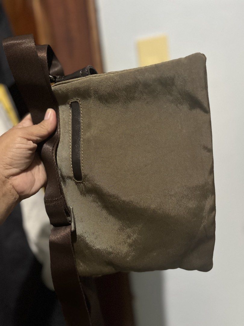Tokyo Enshinsho Messenger Bag (Category: Sling Bags) located in Daanbantayan. Submitted by christinet58475 (Listing ID 1425539243, Image 2). Description: Messenger bag features a brown and olive green color scheme. It has a main compartment and multiple interior pockets. The bag has a shoulder strap and a zipper closure. The brand name "Tokyo Enshinsho" is visible on the front of the bag..