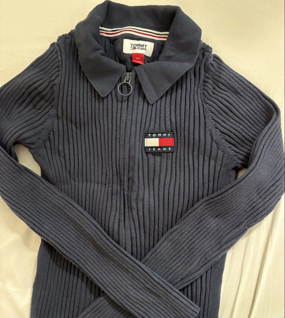 Tommy Jeans Ribbed Zip-Up Sweater (Category: Coats, Jackets and Outerwear) located in Manila. Submitted by rarity88 (Listing ID 1425341650, Image 1). Description: Like new Tommy Jeans navy blue sweater features a ribbed design and a zip-up closure. It has a small Tommy Jeans logo patch on the chest. Used only once. Fabric is stretchable. Tag says size S but best fits XS. Made from 80% cotton and 20% nylon. Please note that this needs to be washed