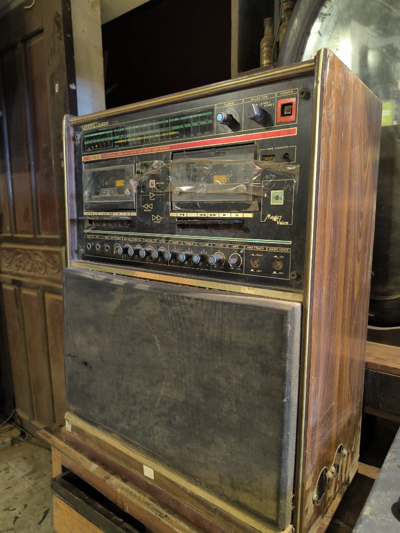 Vintage Magnavox Stereo System (Category: Soundbars, Speakers & Amplifiers) located in Manila. Submitted by makkieenri69972 (Listing ID 1425481767, Image 2). Description: Vintage Magnavox stereo system with radio and dual cassette players. Features a built-in speaker system. Includes various knobs and controls for audio adjustment. The unit has a wooden cabinet and a gold-colored trim..