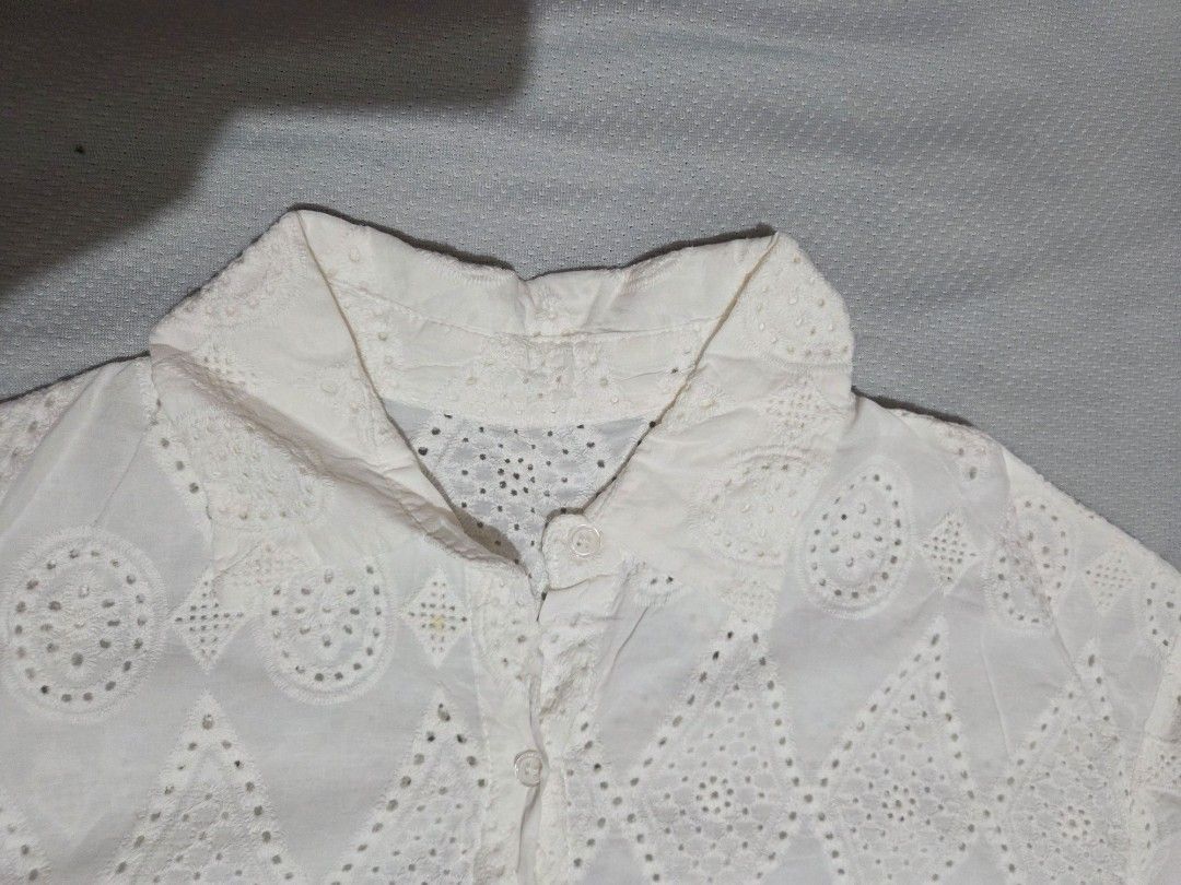 White Eyelet Top (Category: Sleeveless) located in Manila. Submitted by declutterwtly (Listing ID 1425480203, Image 3). Description: Kindly DM me your offers, TYSM 💌 -White eyelet top with button-down closure. -Short sleeves -Detailed geometric pattern. -It has a classic collar and a slightly tailored fit. -The eyelet design adds a touch of elegance and breathability..