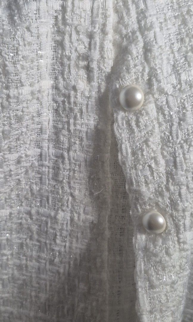 White Tweed Blouse with Sheer Sleeves (Category: Blouses) located in Manila. Submitted by declutter_s (Listing ID 1425578397, Image 2). Description: Made in Korea. Small to Medium Elegant white tweed blouse featuring a square neckline and sheer sleeves. It has button closures down the front. The sleeves have a gathered cuff detail. A perfect addition to your wardrobe for a chic and sophisticated look..