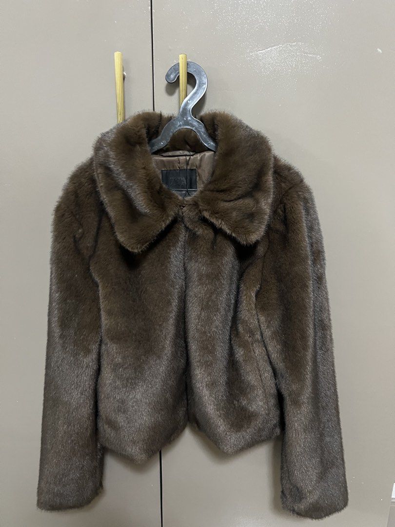 Zara Faux Fur Jacket (Category: Coats, Jackets and Outerwear) located in Manila. Submitted by cluttercrushers (Listing ID 1425452557, Image 1). Description: Brown faux fur jacket from Zara. Features a collared neckline and a cropped length. The jacket has long sleeves and a soft, textured appearance. The jacket is designed with a classic silhouette, suitable for various occasions..