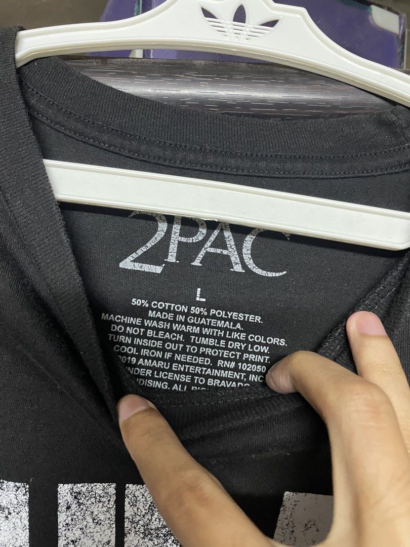 2Pac Black Graphic Tee - Size L (Category: Tshirts & Polo Shirts ) located in Manila. Submitted by 2002kid (Listing ID 1429548957, Image 3). Description: Black 2Pac graphic tee. Features a large print of 2Pac on the front. The back of the shirt is plain black. Made of 50% cotton and 50% polyester. Size L. Made in Guatemala. Under license to Bravado. Size: Large Dimes Width: 18 Length : 28.5 Issue: None 📨.
