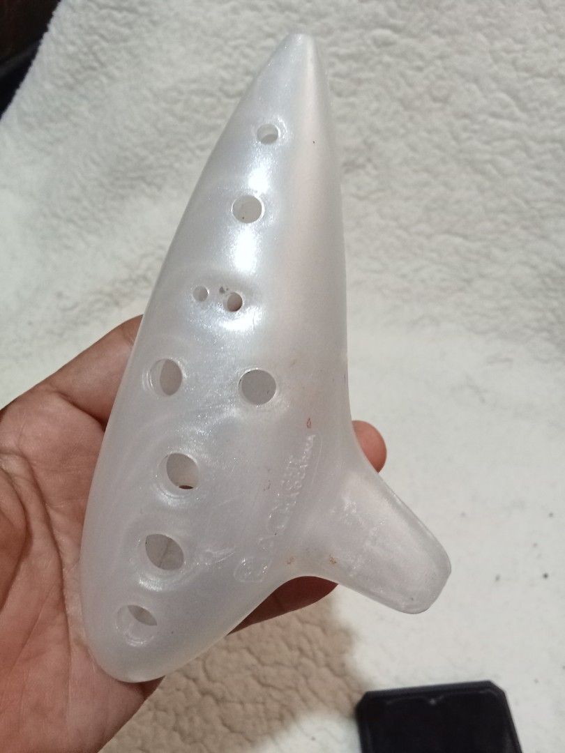 ACNIGHT Ocarina (Category: Musical Instruments) located in Bocaue. Submitted by marajapansurplus (Listing ID 1429561073, Image 1). Description: ACNIGHT ocarina. It has a pearlescent white finish. The ocarina has multiple finger holes. The mouthpiece is located on the bottom right. The brand name is visible on the body of the instrument..