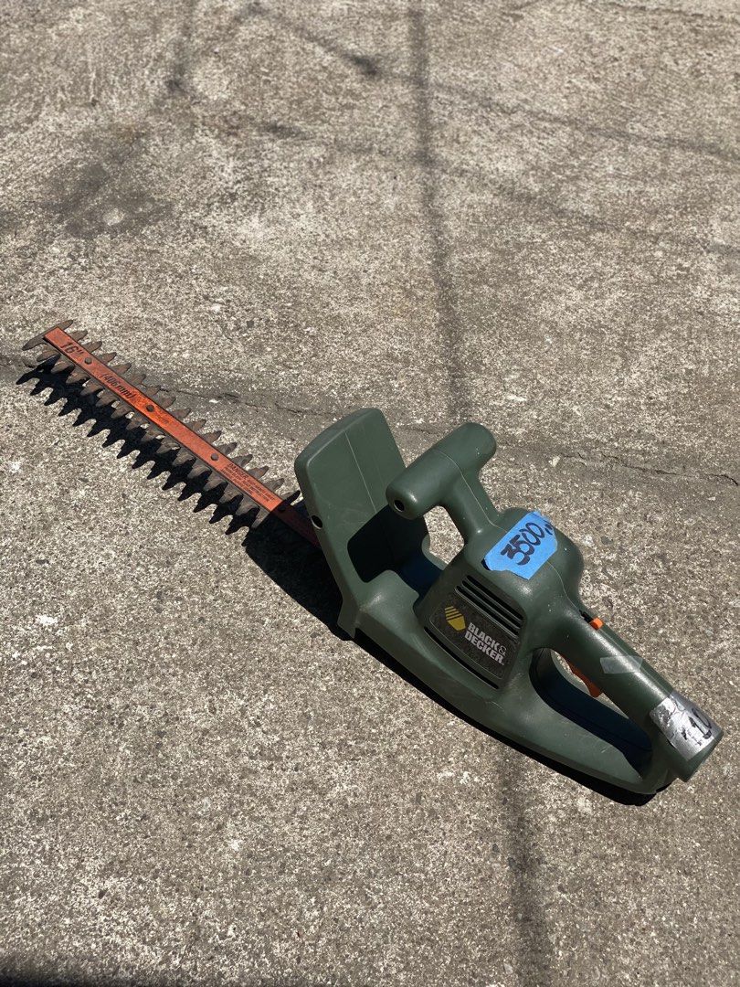 Black & Decker 16" Hedge Trimmer (Category: Gardening Tools & Ornaments) located in Los Banos. Submitted by ejb418 (Listing ID 1429519050, Image 1). Description: Black & Decker hedge trimmer has a 16" (406mm) blade. It is a TR185 Type 3 model, operating at 120V and 2.4A. The trimmer is green and has an orange blade. The price tag on the trimmer indicates a price of ₱. The plug indicates it is a 110V model..