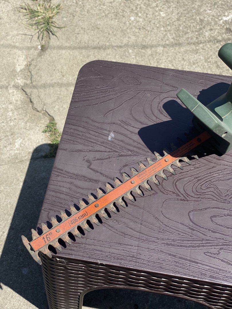 Black & Decker 16" Hedge Trimmer (Category: Gardening Tools & Ornaments) located in Los Banos. Submitted by ejb418 (Listing ID 1429519050, Image 2). Description: Black & Decker hedge trimmer has a 16" (406mm) blade. It is a TR185 Type 3 model, operating at 120V and 2.4A. The trimmer is green and has an orange blade. The price tag on the trimmer indicates a price of ₱. The plug indicates it is a 110V model..