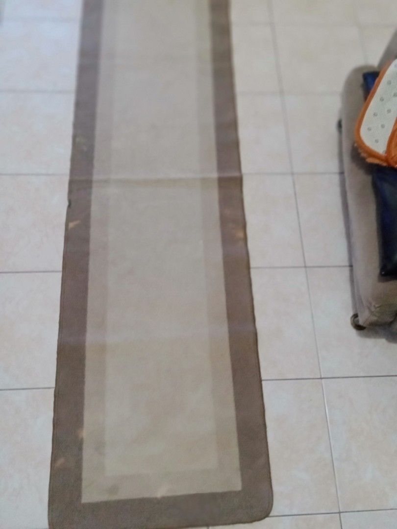 Brown Runner Rug (Category: Carpets, Mats & Flooring) located in Bacoor. Submitted by luxe1820 (Listing ID 1429521977, Image 1). Description: Runner rug features a rectangular shape with a brown border and a lighter beige center. The rug is long and narrow, suitable for hallways or entryways. It has a simple, neutral design that can complement various interior styles..