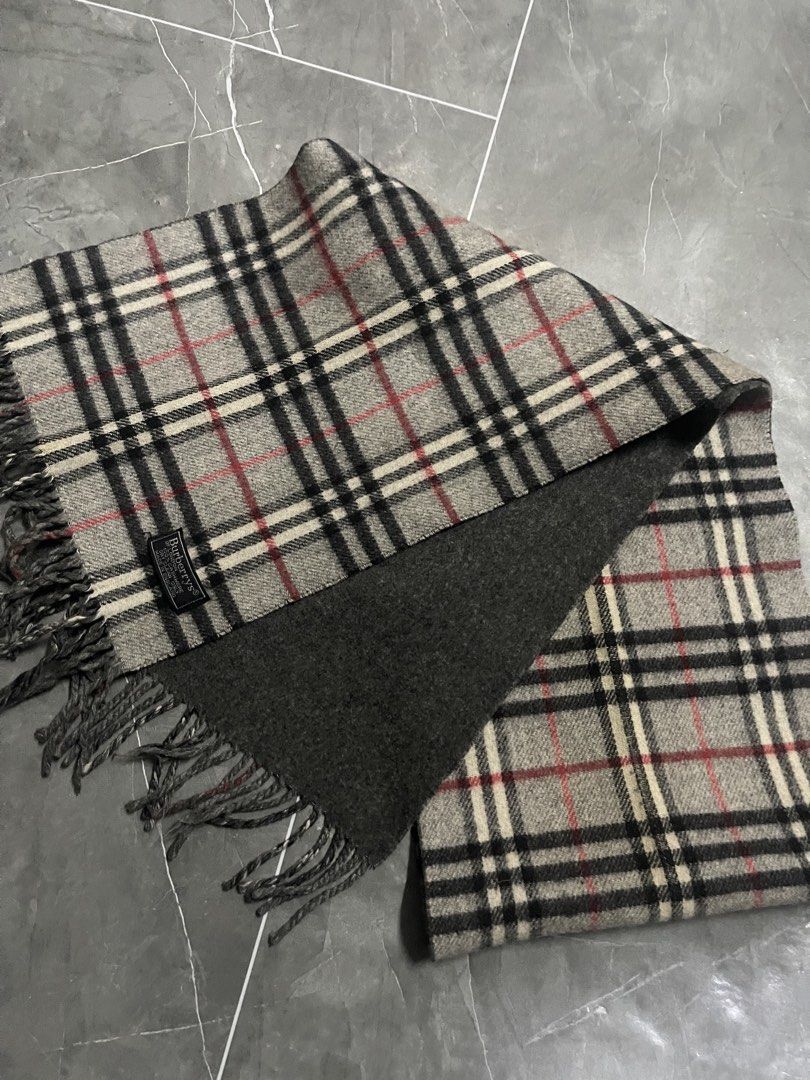 Burberry Checkered Scarf (Category: Scarves) located in Manila. Submitted by flyshitonly_1109 (Listing ID 1429508570, Image 3). Description: Authentic Burberry scarf featuring the iconic checkered pattern. The scarf has a gray base with black, white, and red accents. It includes a Burberry label. The scarf has fringed edges..