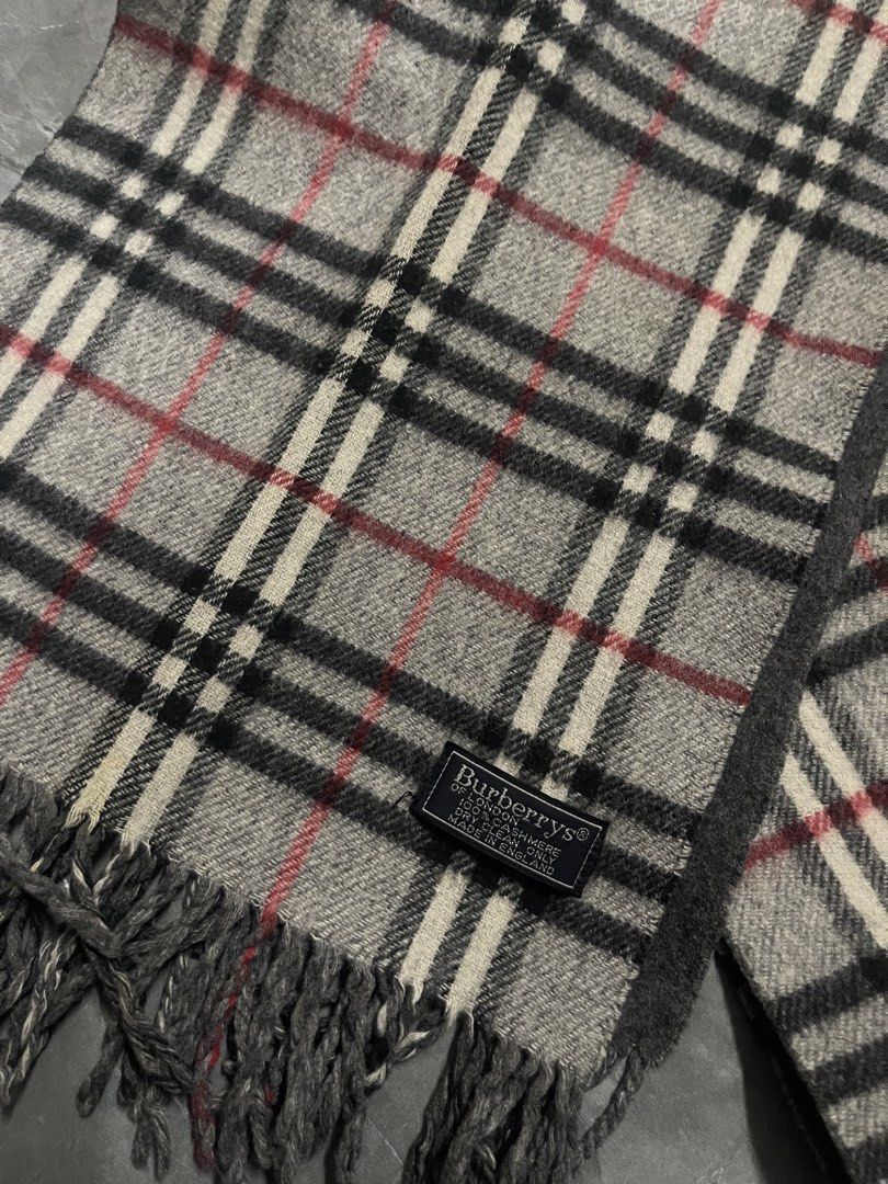 Burberry Checkered Scarf (Category: Scarves) located in Manila. Submitted by flyshitonly_1109 (Listing ID 1429508570, Image 2). Description: Authentic Burberry scarf featuring the iconic checkered pattern. The scarf has a gray base with black, white, and red accents. It includes a Burberry label. The scarf has fringed edges..