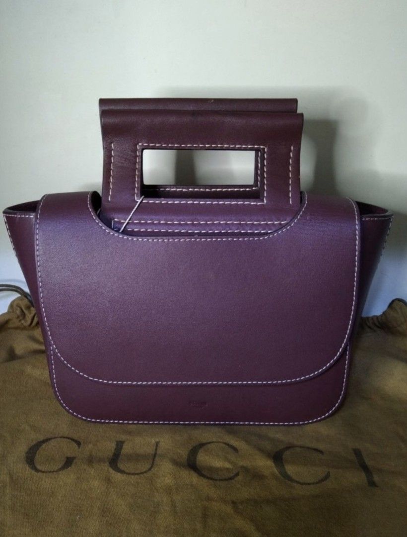 Celine Small Square Handbag Burgundy (Category: Luxury Bags & Wallets) located in Padre Garcia. Submitted by lucky_buelav (Listing ID 1429620770, Image 1). Description: Celine Small Square Handbag in burgundy. Features a unique square shape with a top handle and a flap closure. The bag has white stitching details and a small pocket on the front. Includes a dust bag. The interior has a small pocket. The style code is 184823DLG.28RO..