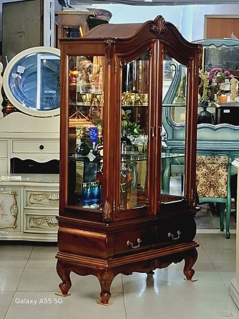 Chippendale-Style Curio Cabinet - From Japan (Category: Shelves, Cabinets & Racks) located in Caloocan City. Submitted by japansurplus29 (Listing ID 1429504950, Image 2). Description: Elegant Chippendale-style curio cabinet. Features glass doors and shelves, perfect for displaying collectibles. Includes two drawers at the bottom. Dimensions: 61 inches height, 33 inches length, and 15 inches width. Crafted from wood with intricate detailing. A bea