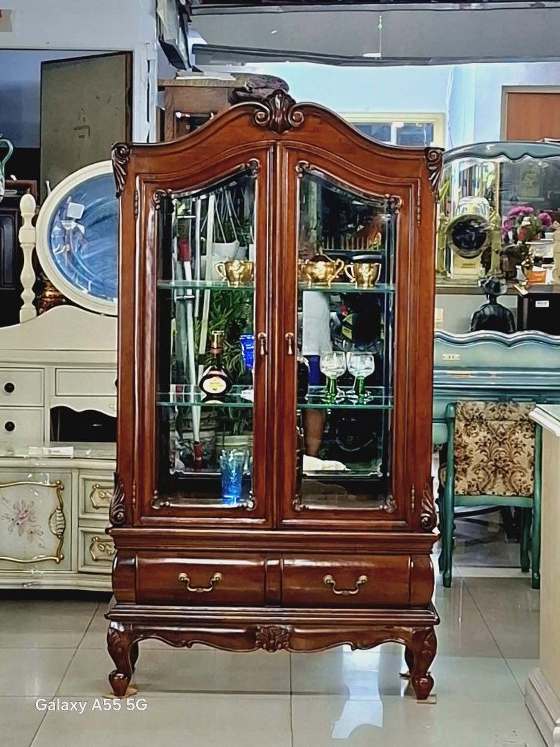 Chippendale-Style Curio Cabinet - From Japan (Category: Shelves, Cabinets & Racks) located in Caloocan City. Submitted by japansurplus29 (Listing ID 1429504950, Image 3). Description: Elegant Chippendale-style curio cabinet. Features glass doors and shelves, perfect for displaying collectibles. Includes two drawers at the bottom. Dimensions: 61 inches height, 33 inches length, and 15 inches width. Crafted from wood with intricate detailing. A bea
