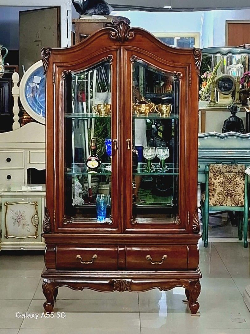 Chippendale-Style Curio Cabinet - From Japan (Category: Shelves, Cabinets & Racks) located in Caloocan City. Submitted by japansurplus29 (Listing ID 1429504950, Image 1). Description: Elegant Chippendale-style curio cabinet. Features glass doors and shelves, perfect for displaying collectibles. Includes two drawers at the bottom. Dimensions: 61 inches height, 33 inches length, and 15 inches width. Crafted from wood with intricate detailing. A bea