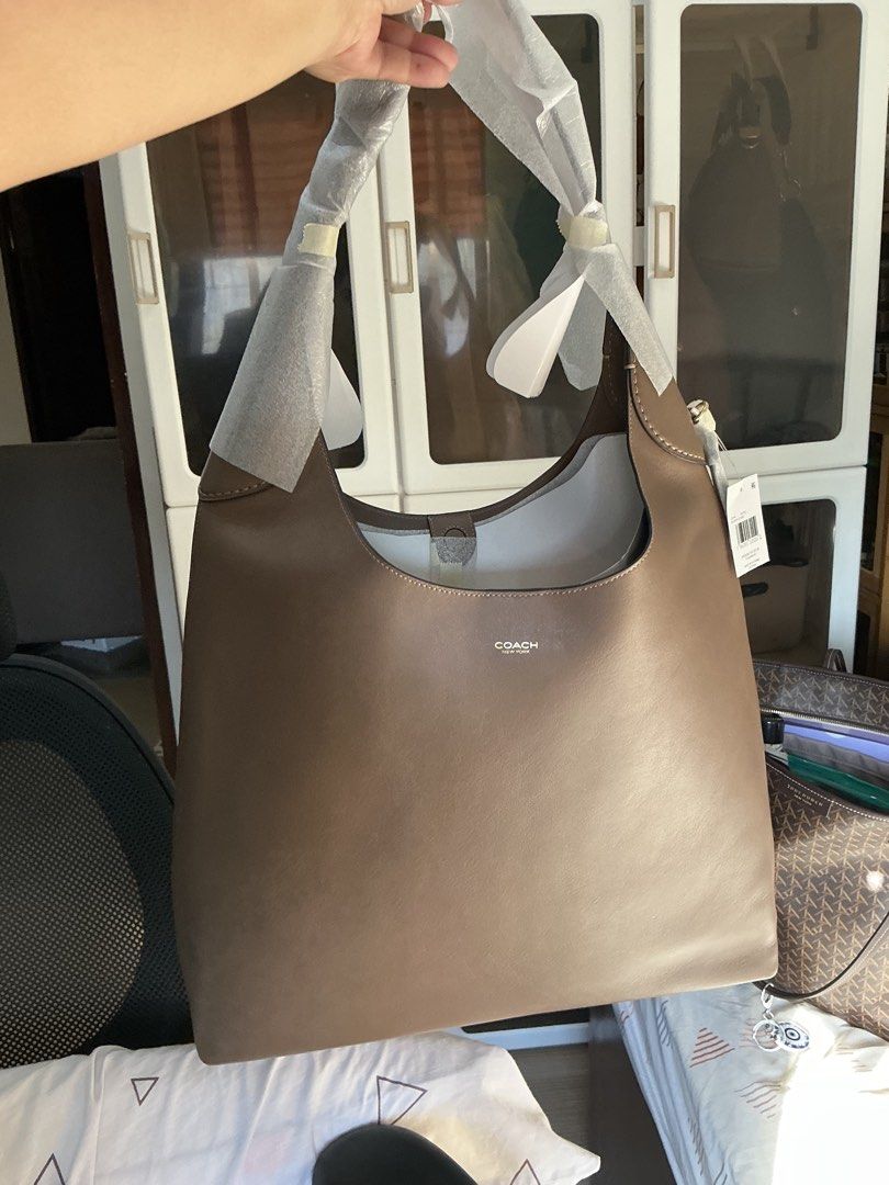 Coach Brooklyn 39 Shoulder Bag - Darkstone (Category: Luxury Bags & Wallets) located in San Pedro. Submitted by misslumi (Listing ID 1429586576, Image 2). Description: Coach Brooklyn shoulder bag in darkstone color. Features a spacious interior and a shoulder strap. Includes a dust bag and original tags. The bag has a magnetic snap closure. The bag is brand new from Canada! Inclusions are dust bag, price tag, paper bag..