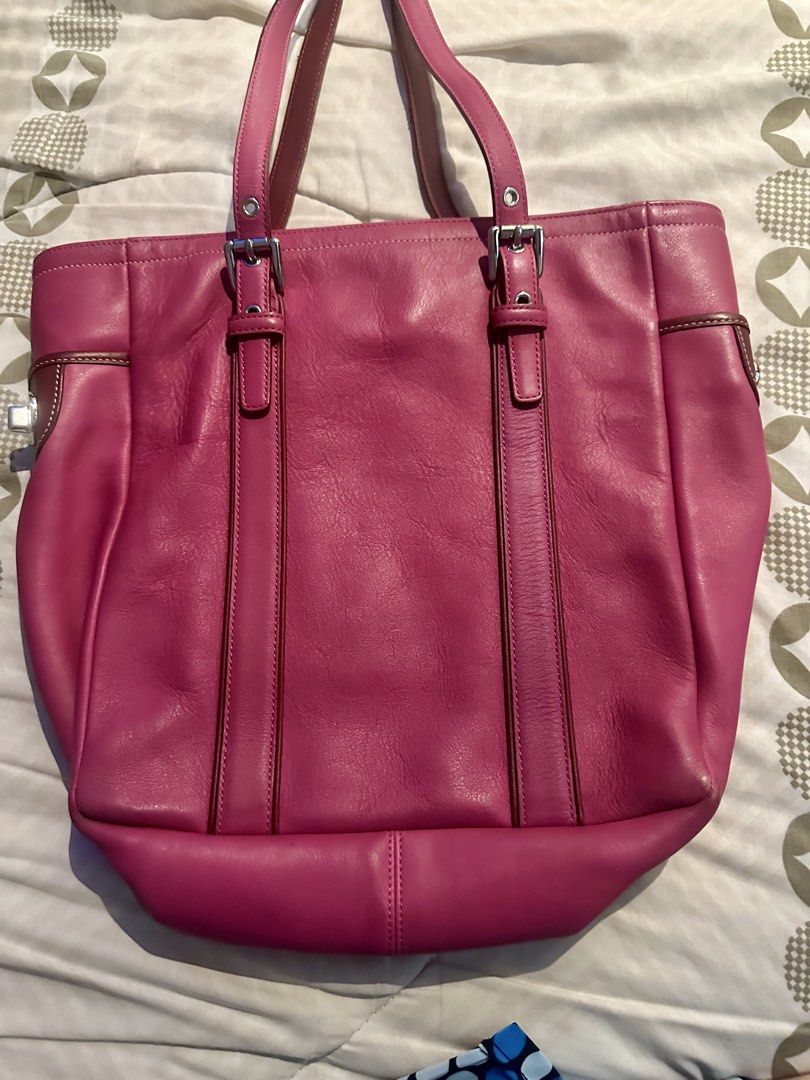 Coach Pink Leather Tote Bag (Category: Luxury Bags & Wallets) located in Makati City. Submitted by tikling65 (Listing ID 1429016879, Image 2). Description: Authentic Coach tote bag in a vibrant pink color. Features a spacious interior with multiple compartments and a zippered closure. The bag has brown leather accents on the handles and trim. Includes a Coach hangtag. The interior lining has a Coach logo pattern. .
