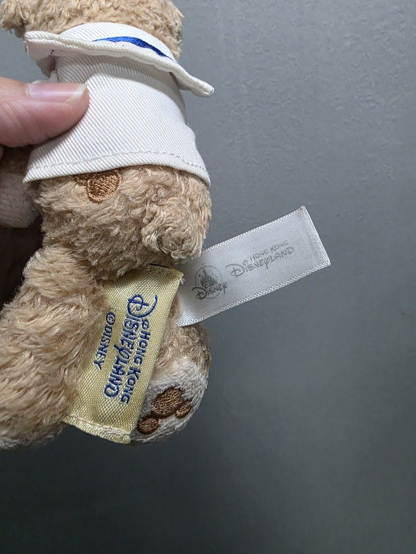Duffy the Disney Bear Plush Keychain Sailor (Category: Plushies & Soft Toys) located in Valenzuela. Submitted by cbianx (Listing ID 1429586585, Image 3). Description: Duffy the Disney Bear plush keychain is from Hong Kong Disneyland. It features Duffy wearing a sailor outfit with a white hat. The plush has a keychain attached. The tag indicates it is an official Disney product..