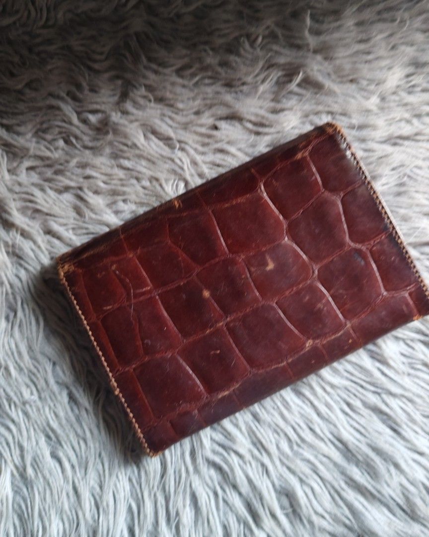 Fino Brown Crocodile-Embossed Wallet (Category: Wallets & Card holders) located in Paranaque City. Submitted by princessitems (Listing ID 1429578491, Image 3). Description: Brown wallet features a crocodile-embossed design. It has a flap closure with a snap button and a zipper compartment inside. It has a rectangular shape and a classic design..