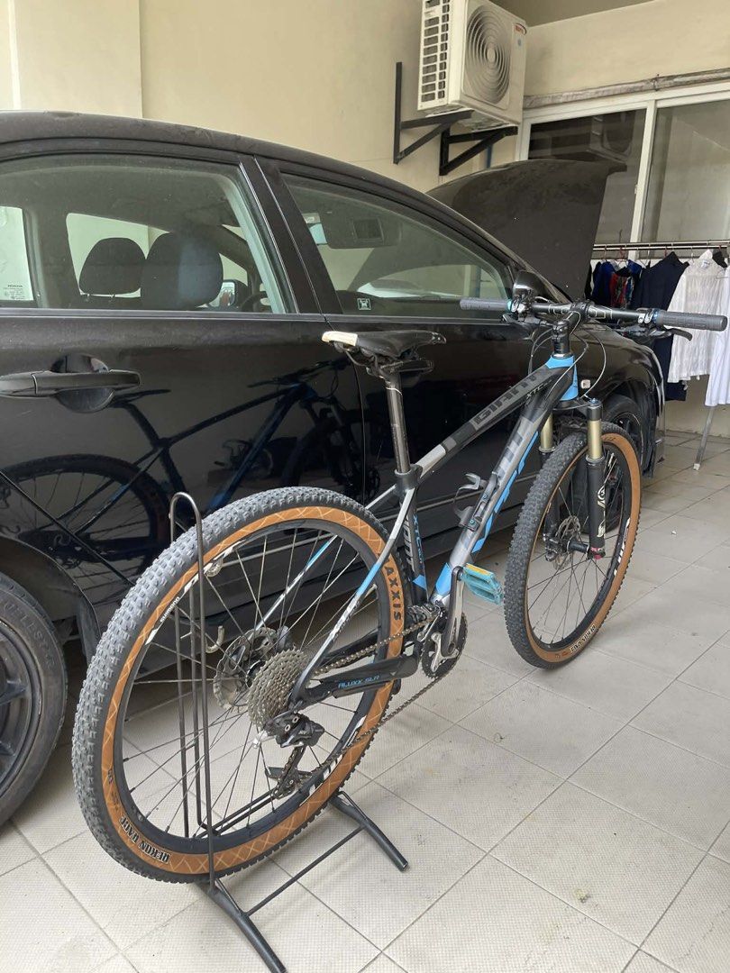 Giant XTC SLR Mountain Bike (Category: Bicycles) located in Marilao. Submitted by love.gisellemarie (Listing ID 1429592982, Image 2). Description: Giant XTC SLR mountain bike features Shimano SLX components and a Fox suspension fork. It has Maxxis tires and a black and blue frame. The bike is equipped with disc brakes and a Shimano XT rear derailleur..