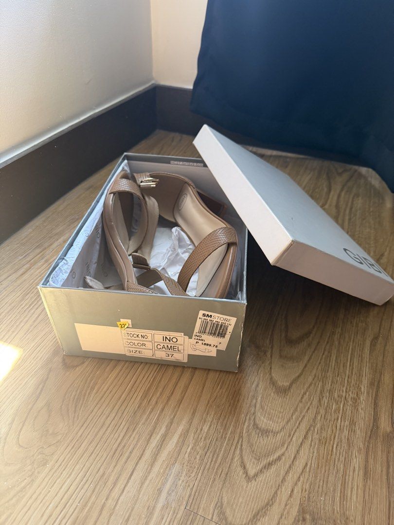 Gibi Camel Sandals Size 37 (Category: Flats & Sandals) located in Pasig City. Submitted by mmmspg (Listing ID 1429650772, Image 1). Description: Gibi camel-colored sandals. Size 37. Features a strap design. The sandals come with their original box. The sole shows some signs of wear..