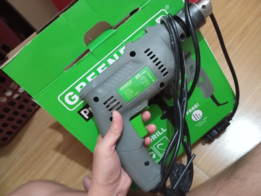 Greenfield ProLite Series 650W Impact Drill (Category: Construction Tools & Equipment) located in Caloocan City. Submitted by arjay_bernarte (Listing ID 1429515551, Image 1). Description: Greenfield ProLite Series 650W Impact Drill. Features 650W power, 13mm chuck capacity, and variable speed. Includes a free item. The box shows the drill's specifications, including voltage and speed. Perfect for various drilling tasks. The drill is gray and gree