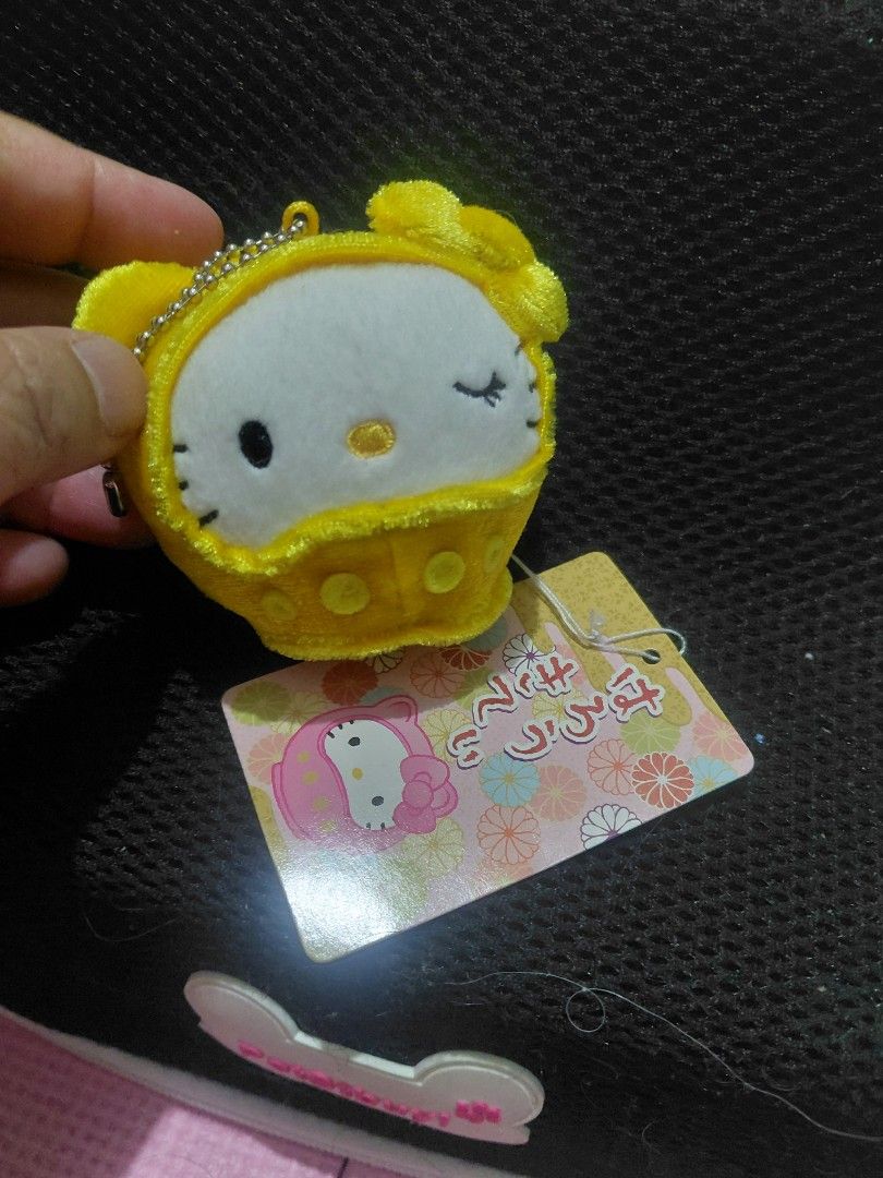 Hello Kitty Clock Keychain (Category: Character Goods) located in Manila. Submitted by bashamylove0116 (Listing ID 1429565369, Image 3). Description: Adorable Kitty keychain in a clock design. Features a yellow plush exterior with Kitty's face on the clock face. Includes a metal chain for easy attachment. Comes with original tags. A cute and functional accessory for any Kitty fan..