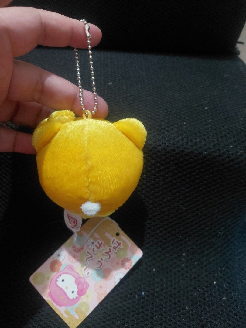Hello Kitty Clock Keychain (Category: Character Goods) located in Manila. Submitted by bashamylove0116 (Listing ID 1429565369, Image 2). Description: Adorable Kitty keychain in a clock design. Features a yellow plush exterior with Kitty's face on the clock face. Includes a metal chain for easy attachment. Comes with original tags. A cute and functional accessory for any Kitty fan..
