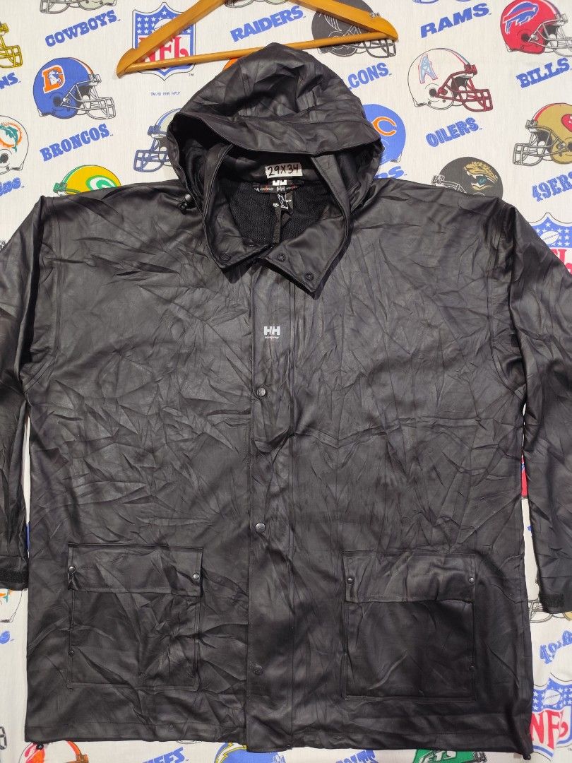 Helly Hansen Black Rain Jacket XXL (Category: Coats, Jackets and Outerwear) located in Baguio. Submitted by FRANKLIN (Listing ID 1429660129, Image 2). Description: Black Helly Hansen rain jacket. Features a hood, button closure, and two front pockets. The jacket is a men's XXL size. Made in China. Outer material is 100% PU, and the back is 100% polyester. The jacket has the HH work wear logo on the front and buttons. The jacket is designed for wo