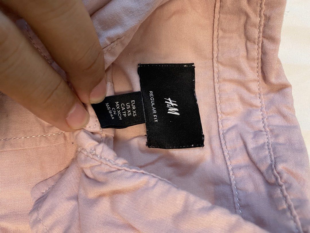 H&M Regular Fit Shirt - XS (Category: Shirts) located in Makati City. Submitted by rye16 (Listing ID 1429564092, Image 2). Description: Pink short-sleeved shirt from H&M. Features a regular fit and a single chest pocket. The shirt has a button-down closure and a classic collar. Size XS. Made from a lightweight fabric, suitable for warm weather. Perfect for casual wear..
