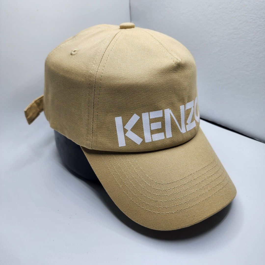 Kenzo Paris Cap (Category: Caps & Hats) located in Quezon City. Submitted by randomthangz (Listing ID 1429577919, Image 2). Description: Tan-colored cap from Kenzo Paris. Features the Kenzo logo vertically on the front. The back has the word "Paris" and the Kenzo logo on the adjustable strap. Includes a size tag..