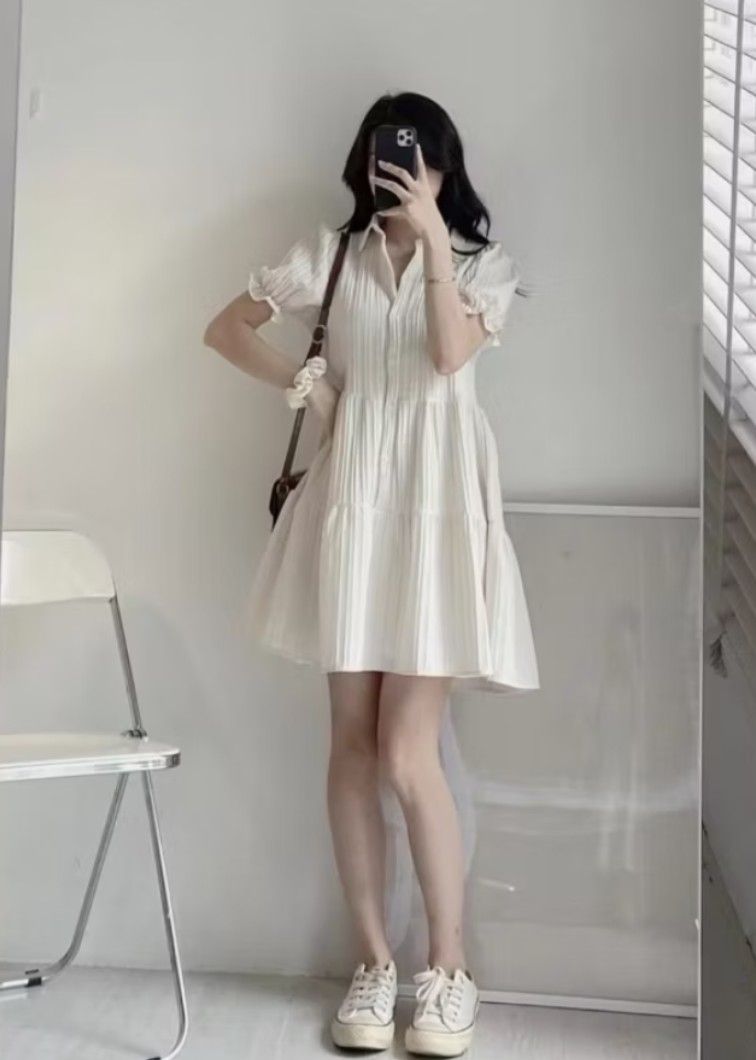Korean Plain Polo Mini Dress (White) (Category: Dresses) located in Quezon City. Submitted by trishopstuff (Listing ID 1429516816, Image 2). Description: White dress features a pleated design with a collared neckline and short, puffed sleeves. It has a tiered skirt and a button-down front. It is a versatile piece that can be dressed up or down. Used only once for a photoshoot. Fits S-L.