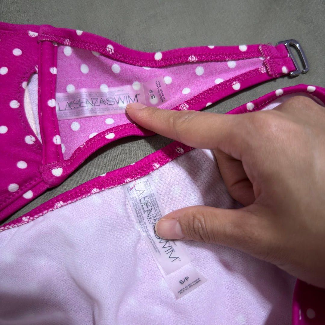 La Senza Swim Polka Dot Bikini Set - Small (Category: Bikinis & Swimsuits) located in Paranaque City. Submitted by _mrs.j (Listing ID 1429594310, Image 2). Description: Bikini set from La Senza Swim features a vibrant pink color with white polka dots. It includes a halter-neck top and a matching bottom. The top has a twist detail at the front. Both the top and bottom are size small. The bikini has tie details on the bottom..