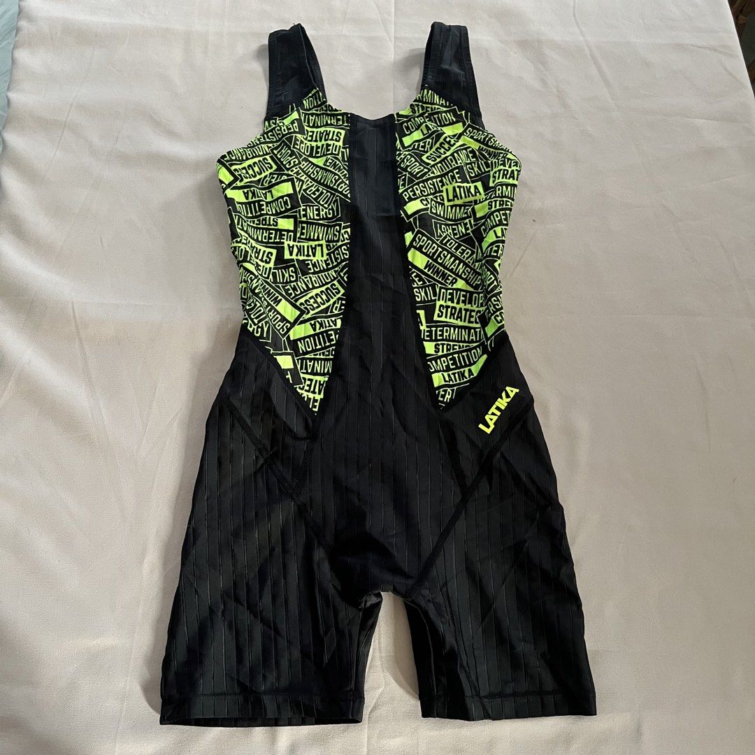 Latika Legsuit (3XS, 70cm) (Category: Babies & Kids Fashion) located in Panabo. Submitted by munch.ph (Listing ID 1429574736, Image 1). Description: Latika legsuit swimwear with a neon green and black design. Features a full-body design with a racerback style. The size is 70 (9-10). Made in Korea. The swimsuit has a unique design with words printed all over the neon green area. The material composition is 80% polyester and 20% polyurethane..