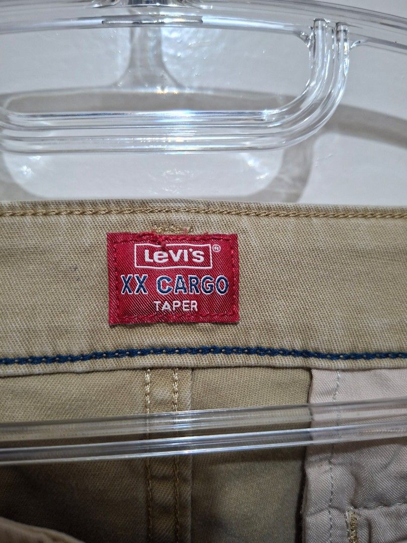 Levi's XX Cargo Taper Pants (Category: Jeans) located in Paranaque City. Submitted by potatoiceblended (Listing ID 1429538575, Image 2). Description: Levi's XX Cargo Taper pants in a beige color. Features a tapered fit and cargo pockets. The size is W30 L30. Made in China. The pants have a Waterless label. The care label indicates the pants should be washed in cold water and line dried..