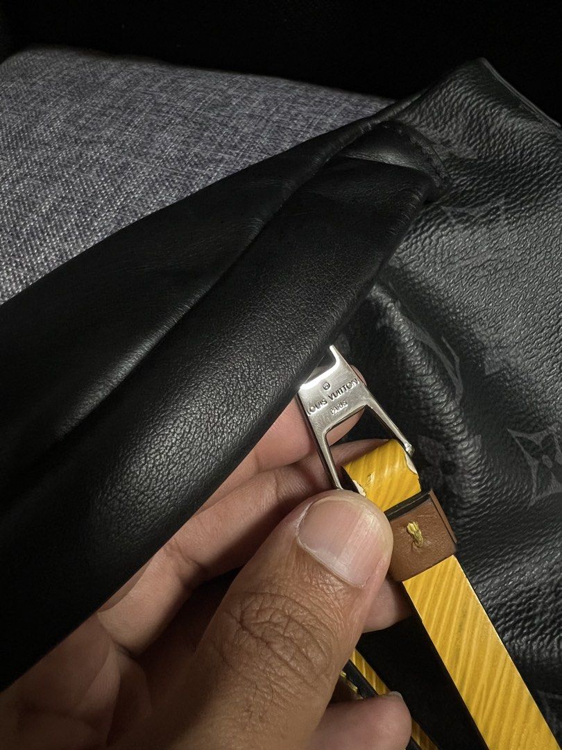 Louis Vuitton Monogram Eclipse Bumbag (Category: Luxury Bags & Wallets) located in Quezon City. Submitted by just.loveclub (Listing ID 1429653776, Image 3). Description: Louis Vuitton Bumbag in Monogram Eclipse canvas. Features a black leather body with the iconic LV monogram pattern. Includes a yellow and brown leather tag with the Louis Vuitton logo. The bag has a silver buckle and zipper. The interior has a small leather tag with the Louis Vui