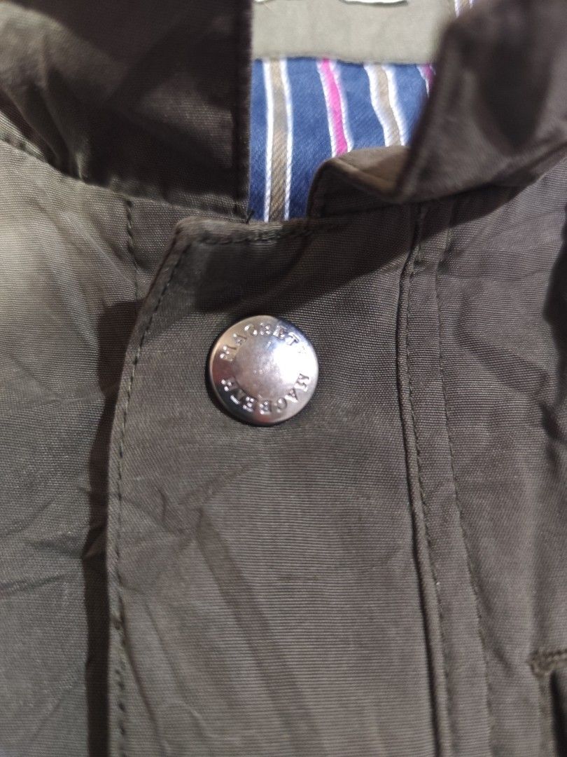 Macbeth Jeans Company Vest - Size L (Category: Vests) located in Baguio. Submitted by FRANKLIN (Listing ID 1429660142, Image 3). Description: Macbeth Jeans Company vest in olive green. Features a button-up front, a small chest pocket, and a striped lining. The vest has a classic collar and a quilted back. Size L. Made with polyester and cotton. The vest has a tag with washing instructions..
