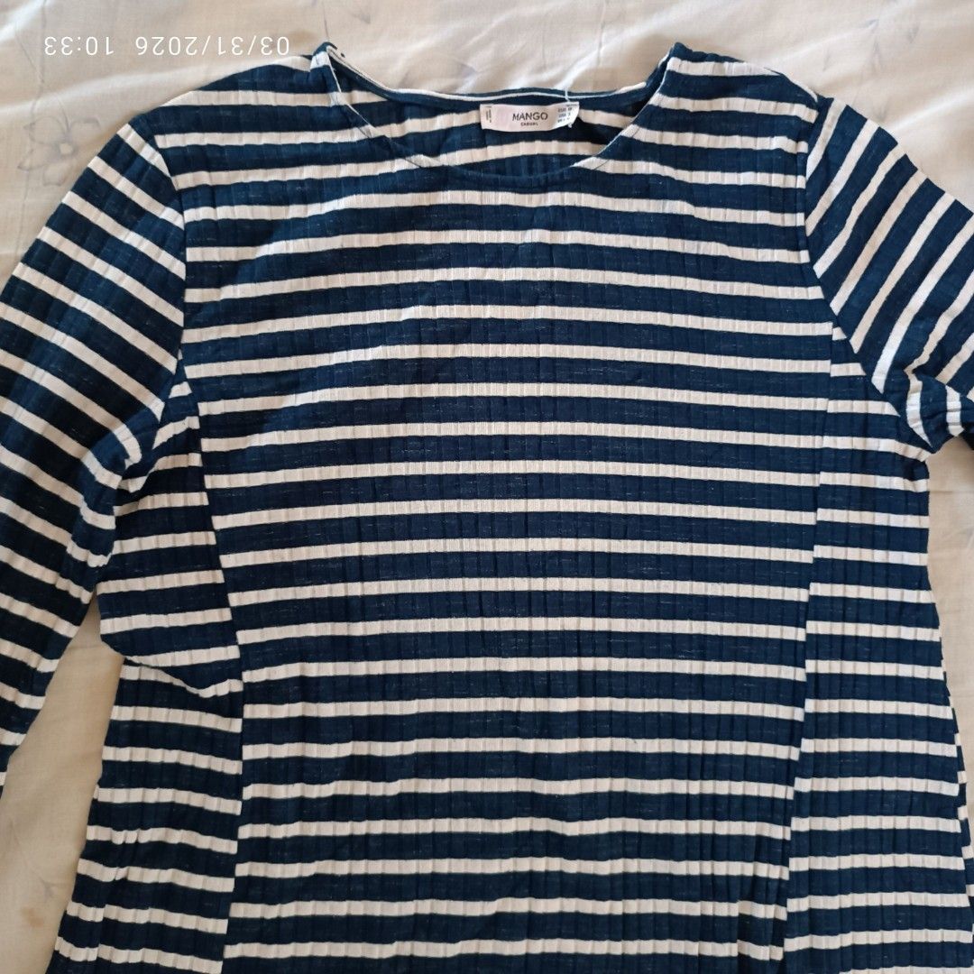 Mango Striped Dress (Category: Dresses) located in Bacoor. Submitted by pamelott (Listing ID 1429513707, Image 2). Description: Key details: Color & Pattern: Navy blue base with horizontal white stripes throughout Sleeves: Long sleeves, slightly fitted Neckline: Simple round neckline Fit & Shape: Fitted at the top and gradually flares out into an A-line silhouette Length: Looks like a knee-length or above-the-knee dress Fabric: Soft, stretchy mat