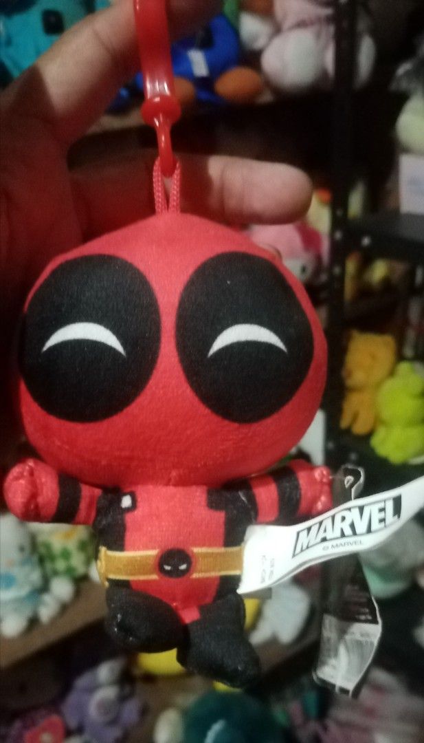 Marvel Deadpool Plushie Keychain (Category: Plushies & Soft Toys) located in Bulacan. Submitted by renasophiatoystore2020 (Listing ID 1429620424, Image 1). Description: Adorable Deadpool plushie is perfect for any Marvel fan! It features a keychain attachment, making it easy to bring Deadpool with you wherever you go. The plushie has a vibrant red and black color scheme, with the iconic Deadpool logo on the tag. It's a great collectible item or a