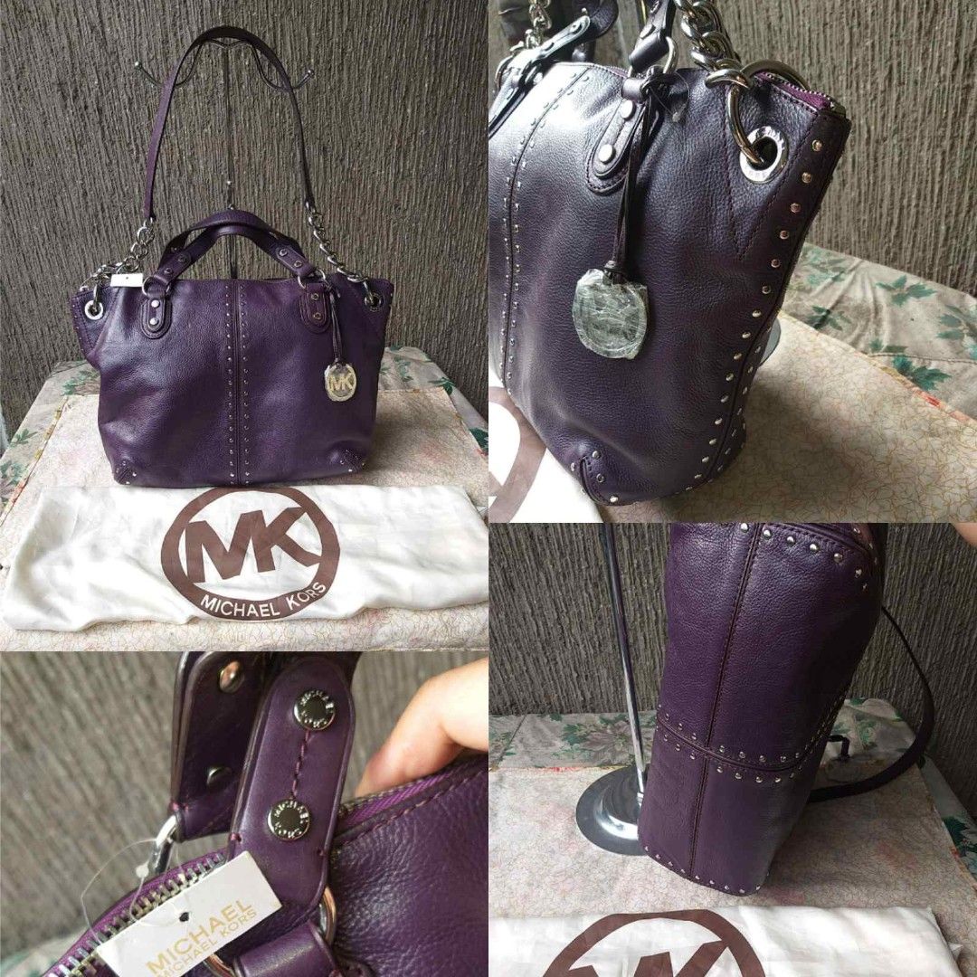 Michael Kors Purple Studded Leather Handbag (Category: Luxury Bags & Wallets) located in Manila. Submitted by onlinesmartshopping12 (Listing ID 1429542252, Image 2). Description: Authentic Michael Kors handbag diakàin a rich purple color. Features silver-tone hardware, including chain straps and studded accents. Includes a dust bag and original tags. The interior lining is a light beige with the Michael Kors logo. The bag has a top zipper closure