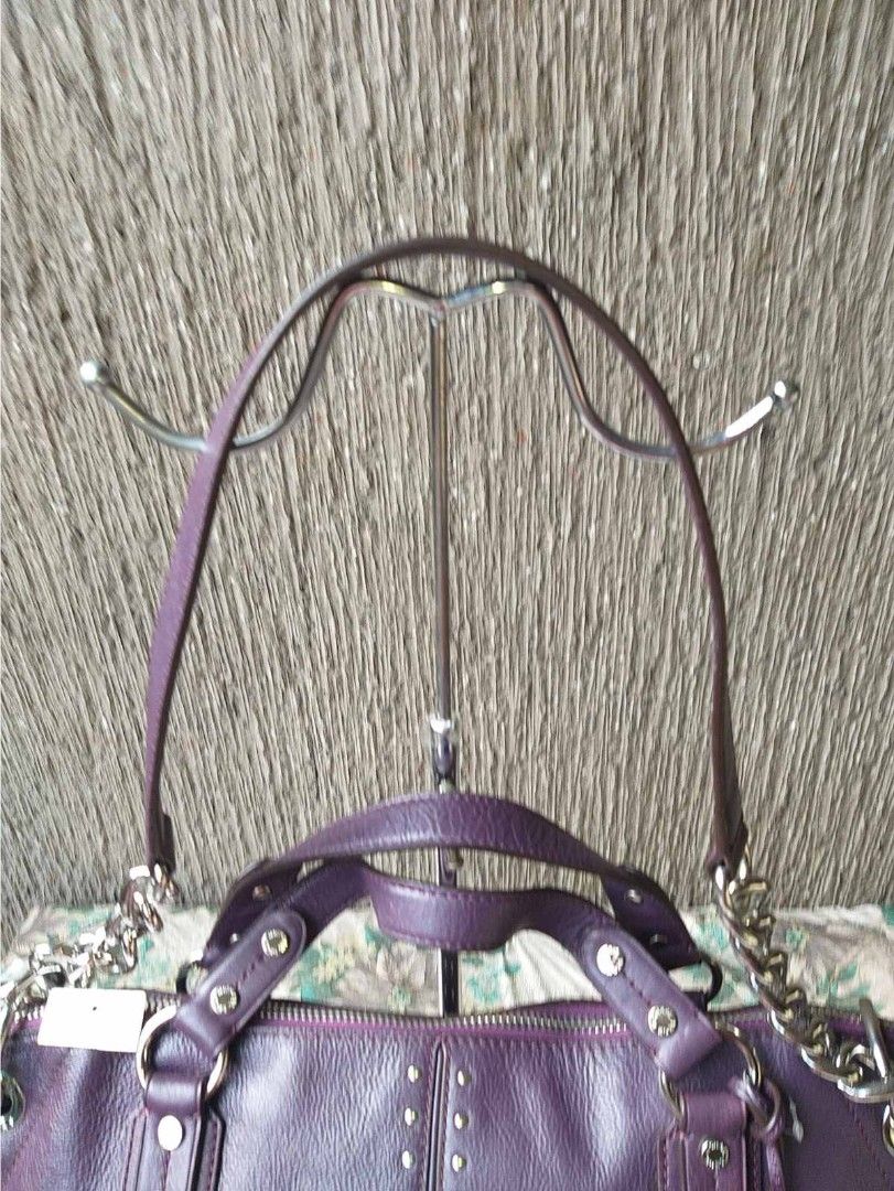Michael Kors Purple Studded Leather Handbag (Category: Luxury Bags & Wallets) located in Manila. Submitted by onlinesmartshopping12 (Listing ID 1429542252, Image 1). Description: Authentic Michael Kors handbag diakàin a rich purple color. Features silver-tone hardware, including chain straps and studded accents. Includes a dust bag and original tags. The interior lining is a light beige with the Michael Kors logo. The bag has a top zipper closure