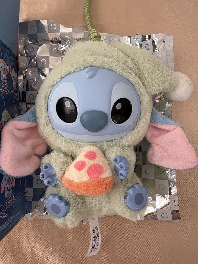 Miniso Disney Stitch Plush Toy (Category: Plushies & Soft Toys) located in Bulacan. Submitted by Padmeph (Listing ID 1429566329, Image 2). Description: - Miniso Disney Stitch plush toy - From the 'Eat Something Before Sleep' series - Features Stitch in sleepwear holding pizza - Blind box: 7 designs to collect - Vinyl plush toy - Perfect for Disney fans and collectors.
