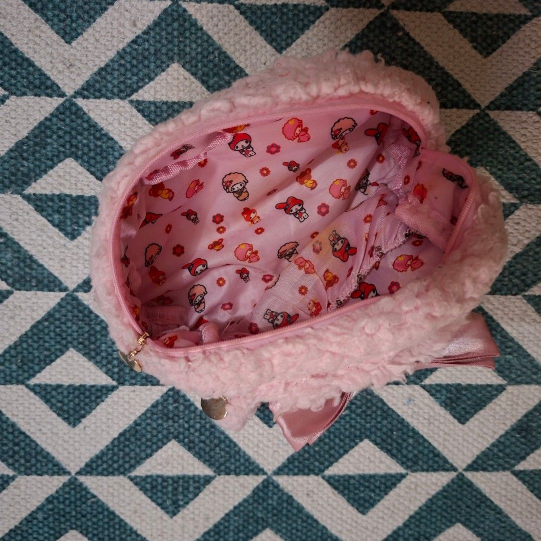 My Melody Pink Plush makeup pouch (Category: Purses & Pouches) located in Manila. Submitted by fandh_essentials (Listing ID 1429586288, Image 3). Description: Adorable My Melody plush pouch in a soft pink color. Features a cute bow detail and a zipper closure. The interior is lined with a My Melody print. Perfect for storing small items like cosmetics or accessories. A charming and functional accessory for any My Melody fan..