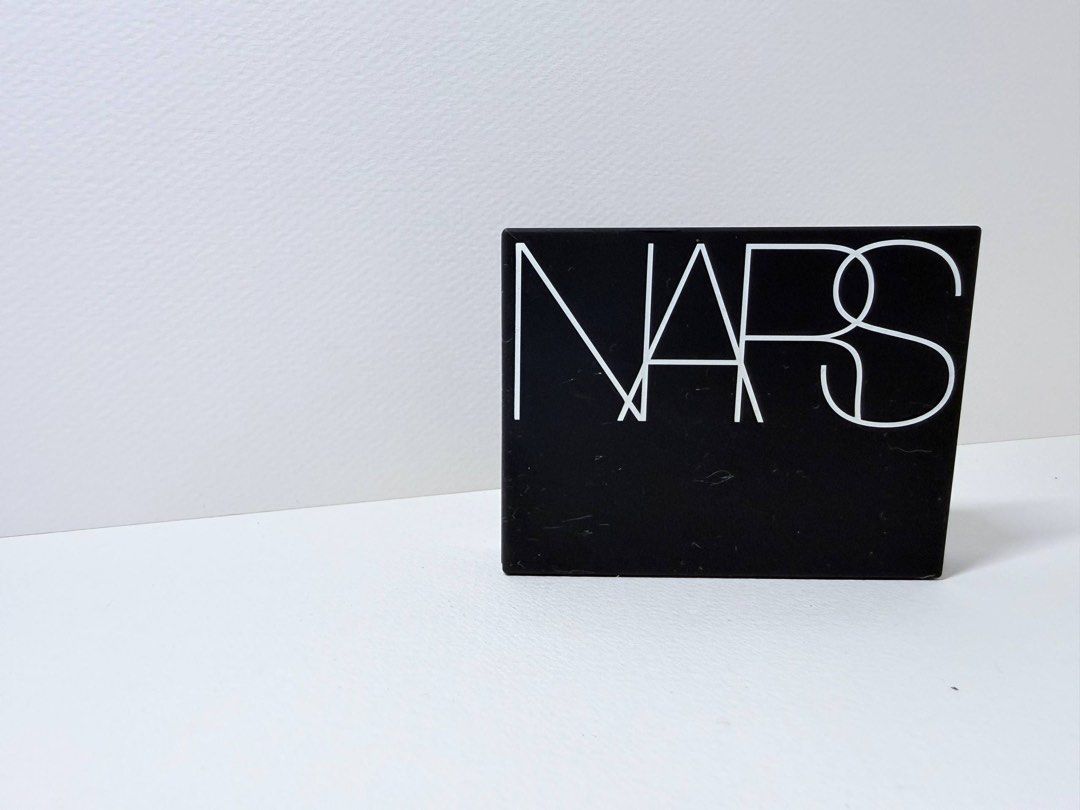 NARS Light Reflecting Setting Powder - Crystal (Category: Makeup) located in Mandaluyong City. Submitted by lgariba (Listing ID 1429610031, Image 1). Description: NARS Light Reflecting Setting Powder in Crystal. This pressed powder is designed to set makeup and provide a light-reflecting finish. The compact includes a mirror and a powder puff. The product details on the back indicate it is the translucent version. Net weight is 0.35 oz / 10 g. No