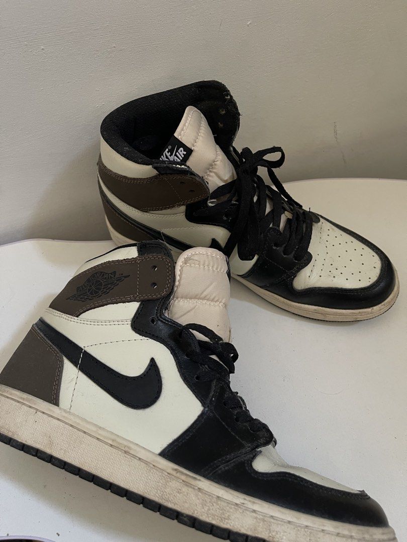 Nike Air Jordan 1 High OG (Category: Sneakers) located in Taguig. Submitted by declutterwithtally (Listing ID 1429504189, Image 1). Description: Classic Nike Air Jordan 1 High OG sneakers. Features a brown, black, and cream colorway. The iconic Nike swoosh is visible on the sides. The shoes have black laces and the Air Jordan wings logo is present. The tongue has the Nike Air logo..