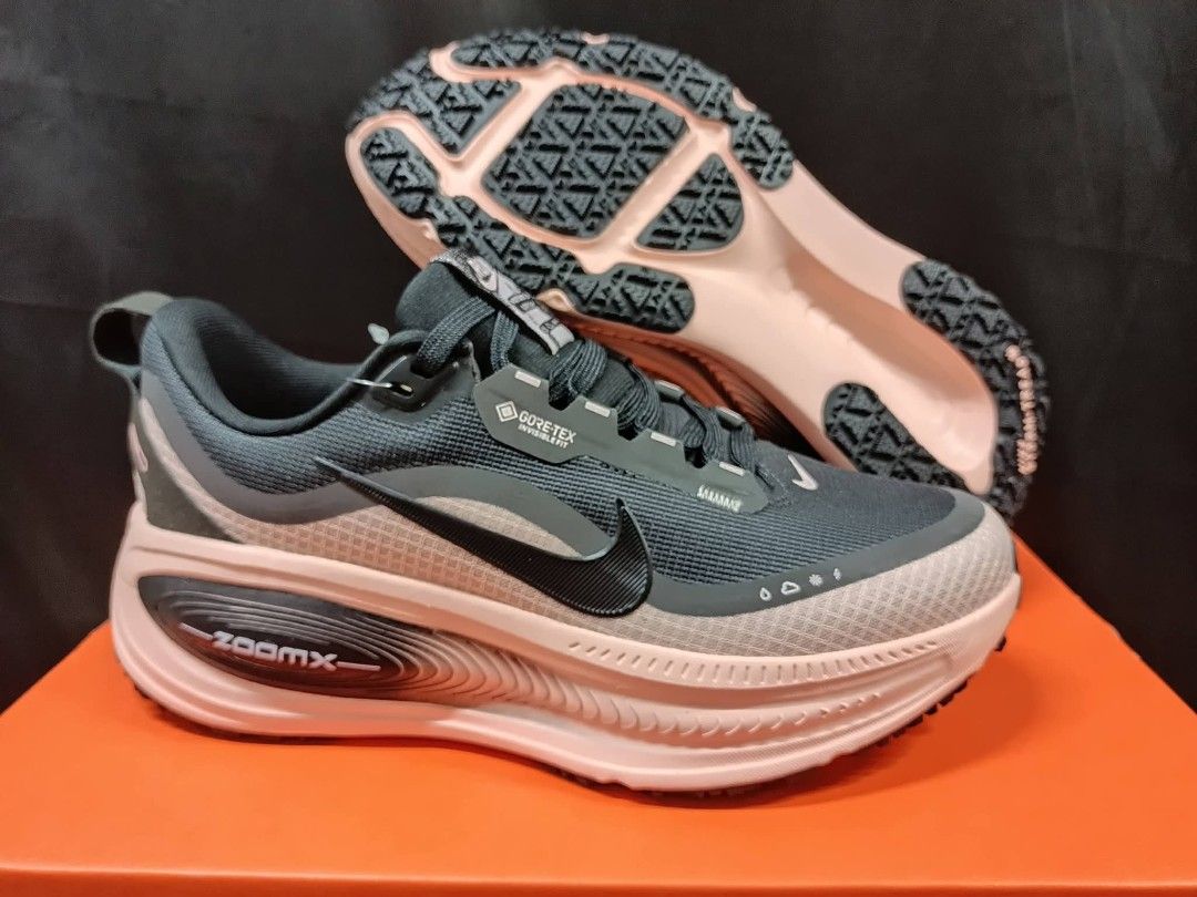 Nike ZoomX Invincible Run Flyknit Gore-Tex (Category: Sneakers) located in Taguig. Submitted by paalooksneakerhub (Listing ID 1429541946, Image 2). Description: Nike ZoomX Invincible Run Flyknit Gore-Tex sneakers. Features a dark teal upper with a pink and white sole. Includes the Nike swoosh logo on the side. The sole has a ZoomX marking. The shoes have a Gore-Tex label. The shoes are on top of an orange box..