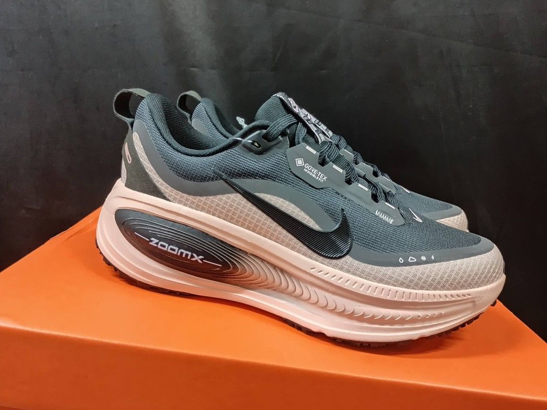 Nike ZoomX Invincible Run Flyknit Gore-Tex (Category: Sneakers) located in Taguig. Submitted by paalooksneakerhub (Listing ID 1429541946, Image 1). Description: Nike ZoomX Invincible Run Flyknit Gore-Tex sneakers. Features a dark teal upper with a pink and white sole. Includes the Nike swoosh logo on the side. The sole has a ZoomX marking. The shoes have a Gore-Tex label. The shoes are on top of an orange box..