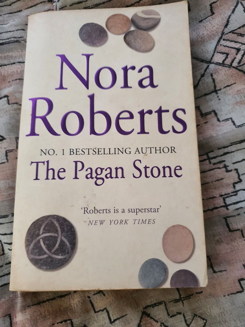 Nora Roberts The Pagan Stone (Category: Storybooks) located in Quezon City. Submitted by cuiquesuum (Listing ID 1429553108, Image 1). Description: Light, foxing spots and a tanned oxidation to the pages. The binding is secure. There is a 2-line writing on the first page by the previous owner. Cover is intact but shows clear, noticeable wear, such as scuffs, minor creases, or edge wear. It is in perfectly readable condition. .