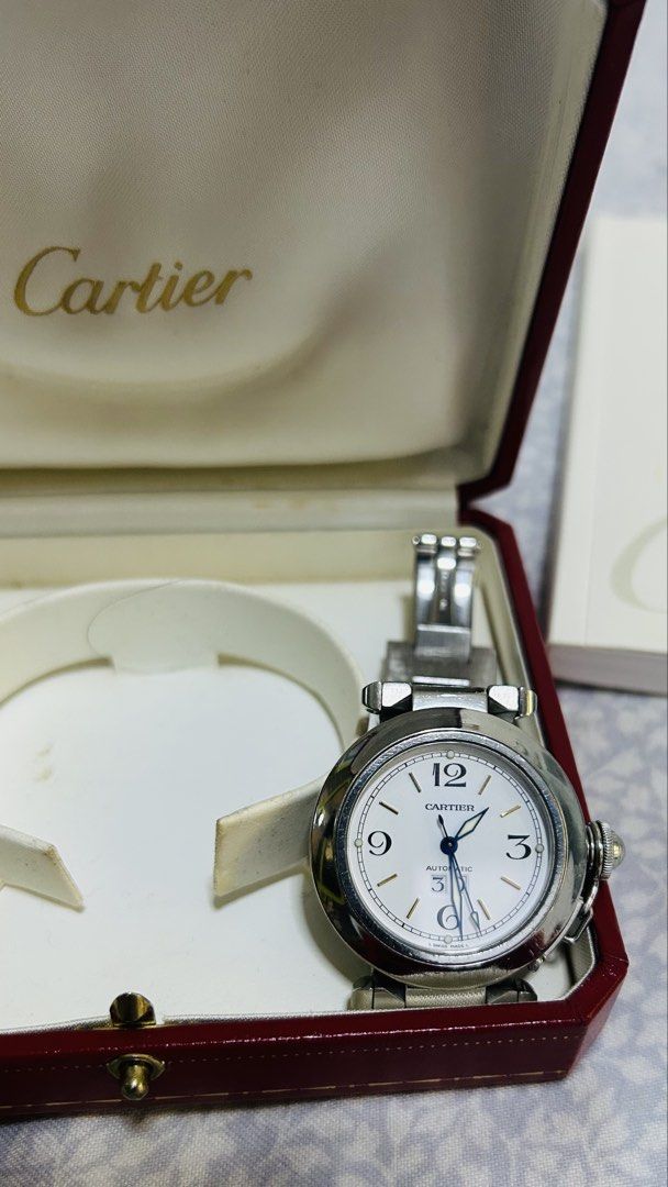 OG Cartier Pasha silver 36mm (Category: Luxury Watches) located in Makati City. Submitted by newhorse.d44ac1 (Listing ID 1429523433, Image 3). Description: - Cartier Pasha de Cartier watch - Silver-tone stainless steel bracelet and case - White dial PB18879 - Classic timepiece - 35mm male female wearable - Automatic - 8.75 rating - 6.5 to 7.5 inches - Excellent working condition - Issue needs polishing from normal wear - with booklet.