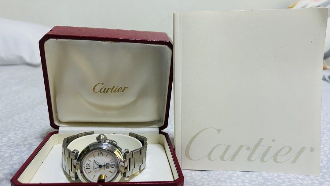 OG Cartier Pasha silver 36mm (Category: Luxury Watches) located in Makati City. Submitted by newhorse.d44ac1 (Listing ID 1429523433, Image 1). Description: - Cartier Pasha de Cartier watch - Silver-tone stainless steel bracelet and case - White dial PB18879 - Classic timepiece - 35mm male female wearable - Automatic - 8.75 rating - 6.5 to 7.5 inches - Excellent working condition - Issue needs polishing from normal wear - with booklet.